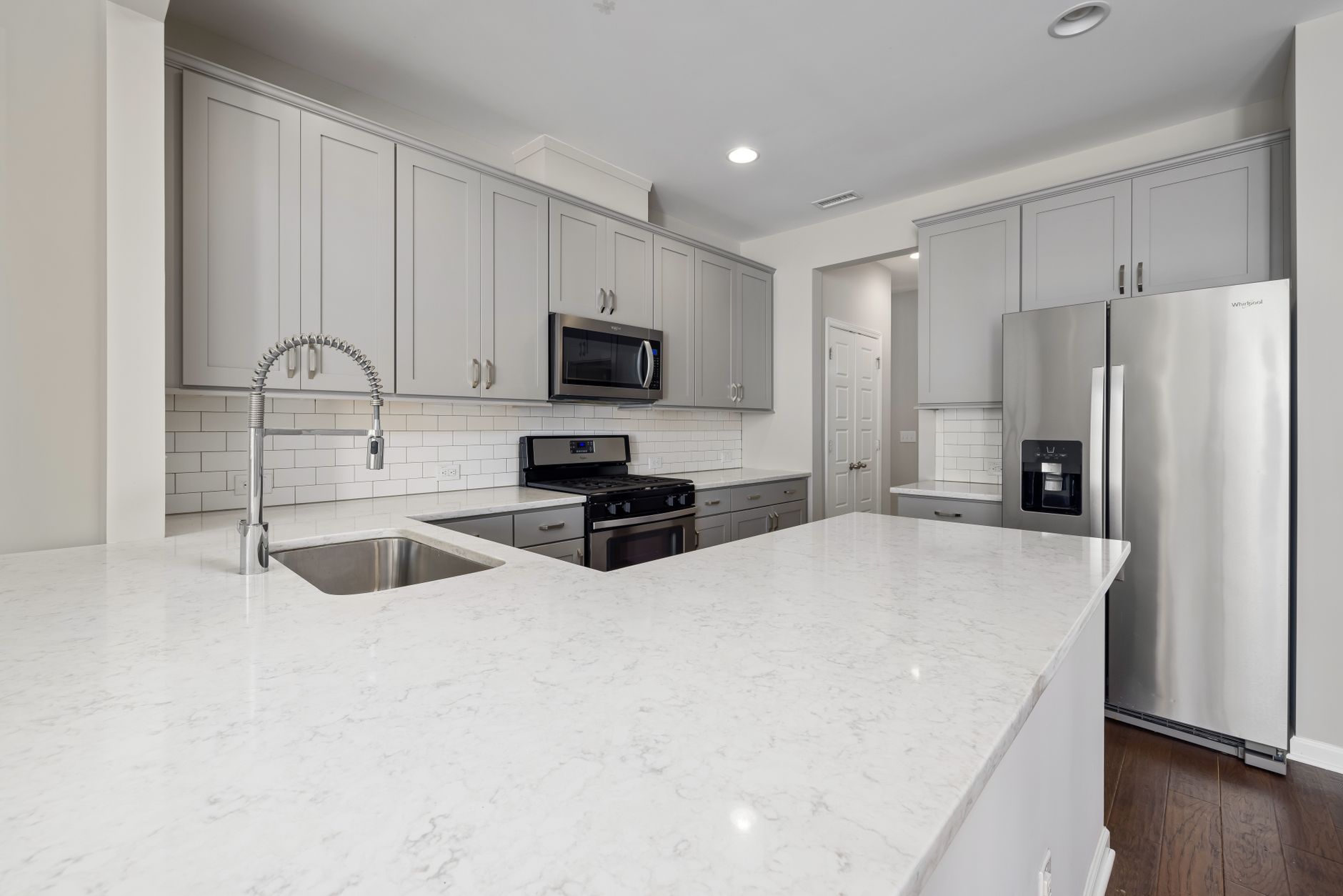 Spacious kitchen featuring stainless steel appliances and sleek countertops
